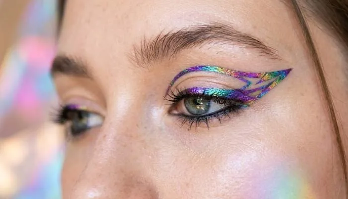 Holographic color-shifting graphic eyeliner accent on the eye lid